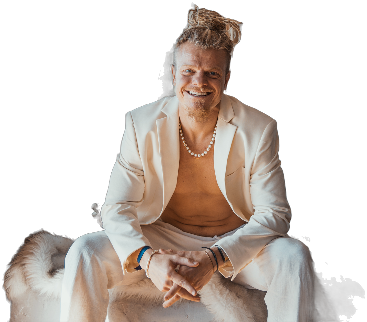 Dr. Evan Johnson seated on a fur bench in a white blazer